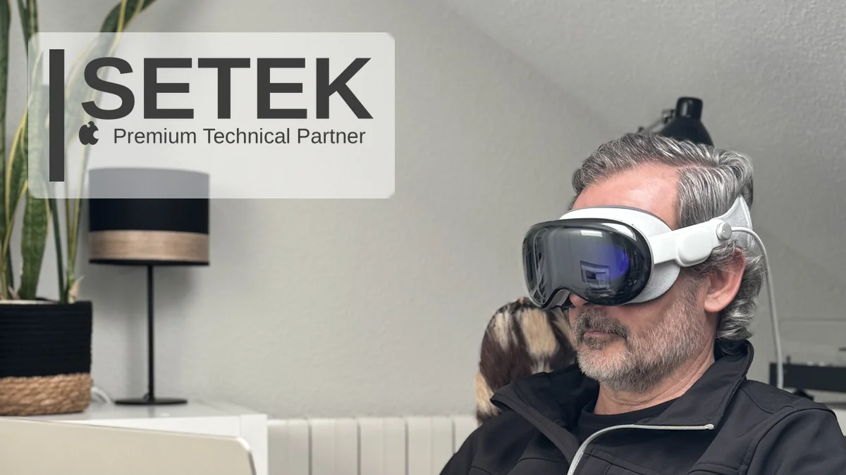 Professional wearing Apple Vision Pro while working on a MacBook at home — Setek, Apple Premium Technical Partner.